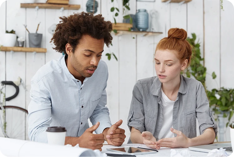 Two professionals collaborating on a project, representing the expert human-in-the-loop approach of Objectways.